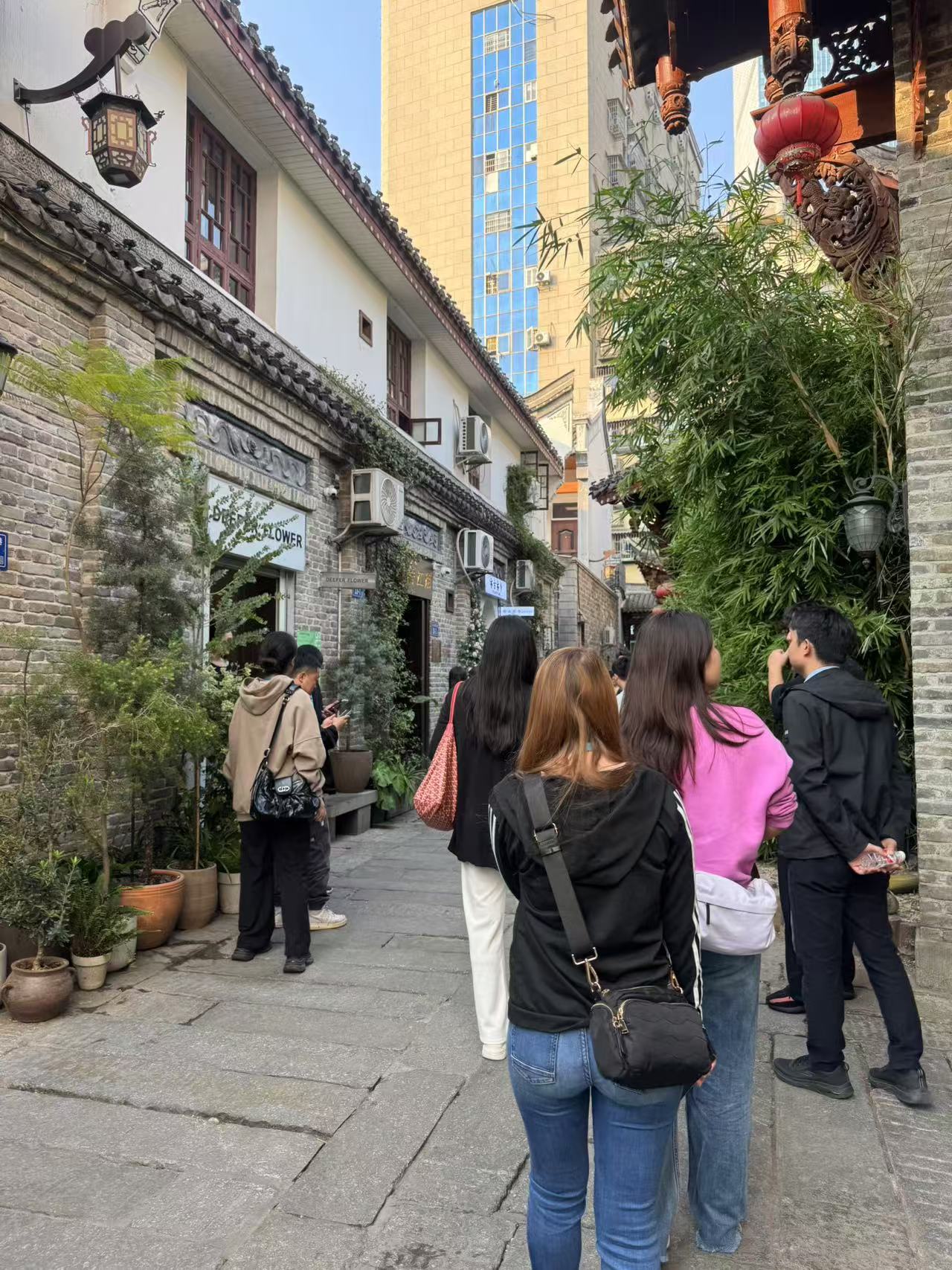 Coffee shops, tea houses and gift shops line the ancient stone-paved street, where modern buildings in the background create a harmonious blend of past and present. Zhou Li/CGTN