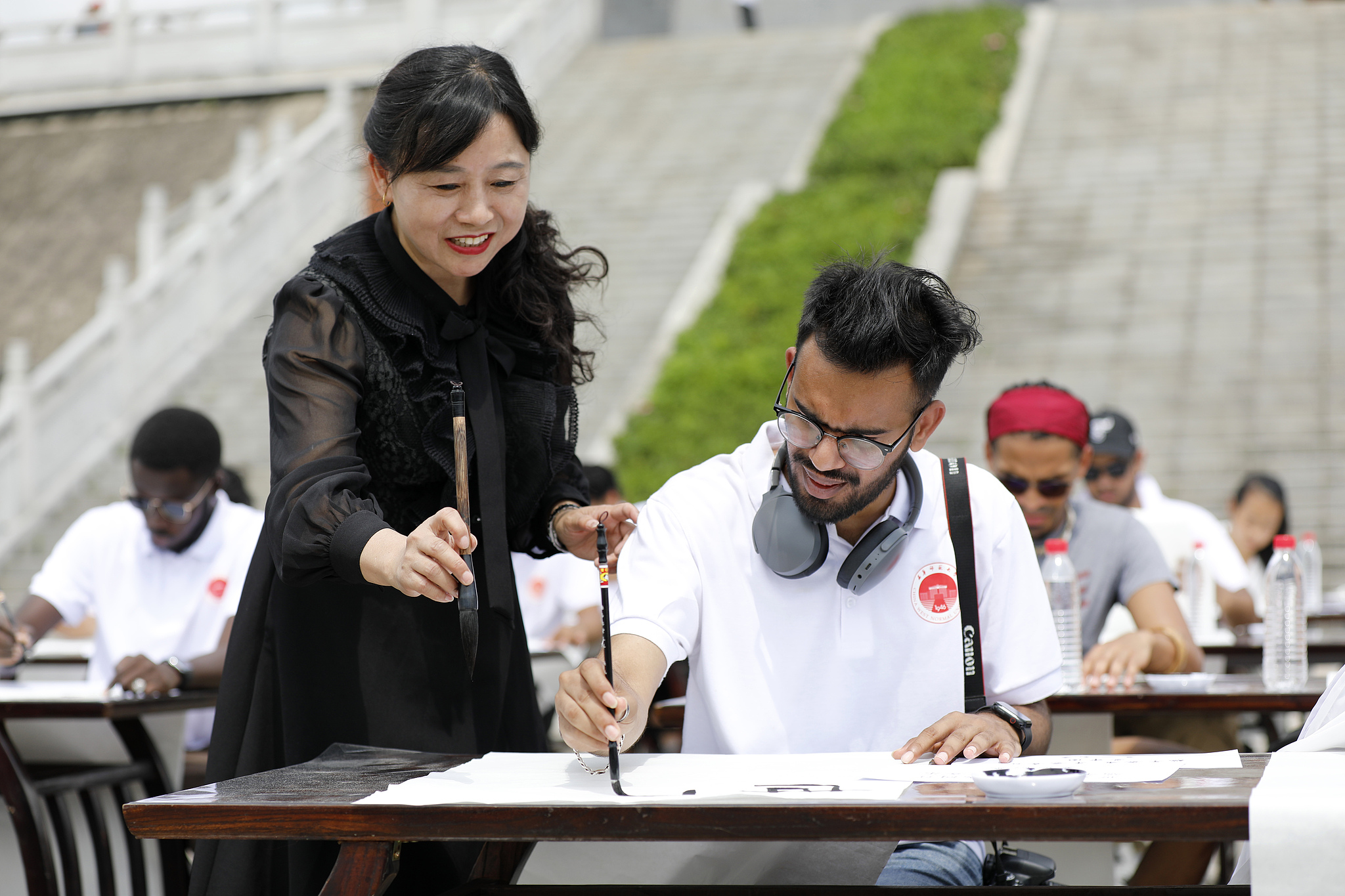 International students from China West Normal University practice calligraphy in southwest China's Sichuan Province, June 9, 2024. /CFP