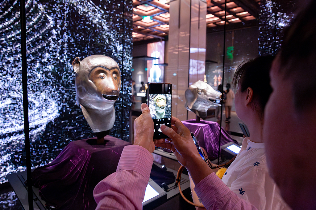 Visitors admire the bronze head of Monkey at the Poly MGM Museum in Macao, November 11, 2024. /CFP