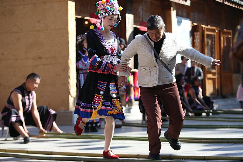 Hani people perform a bamboo dance to celebrate the traditional Hani New Year Festival in Kunming City, Yunnan Province, November 17, 2024. /CFP