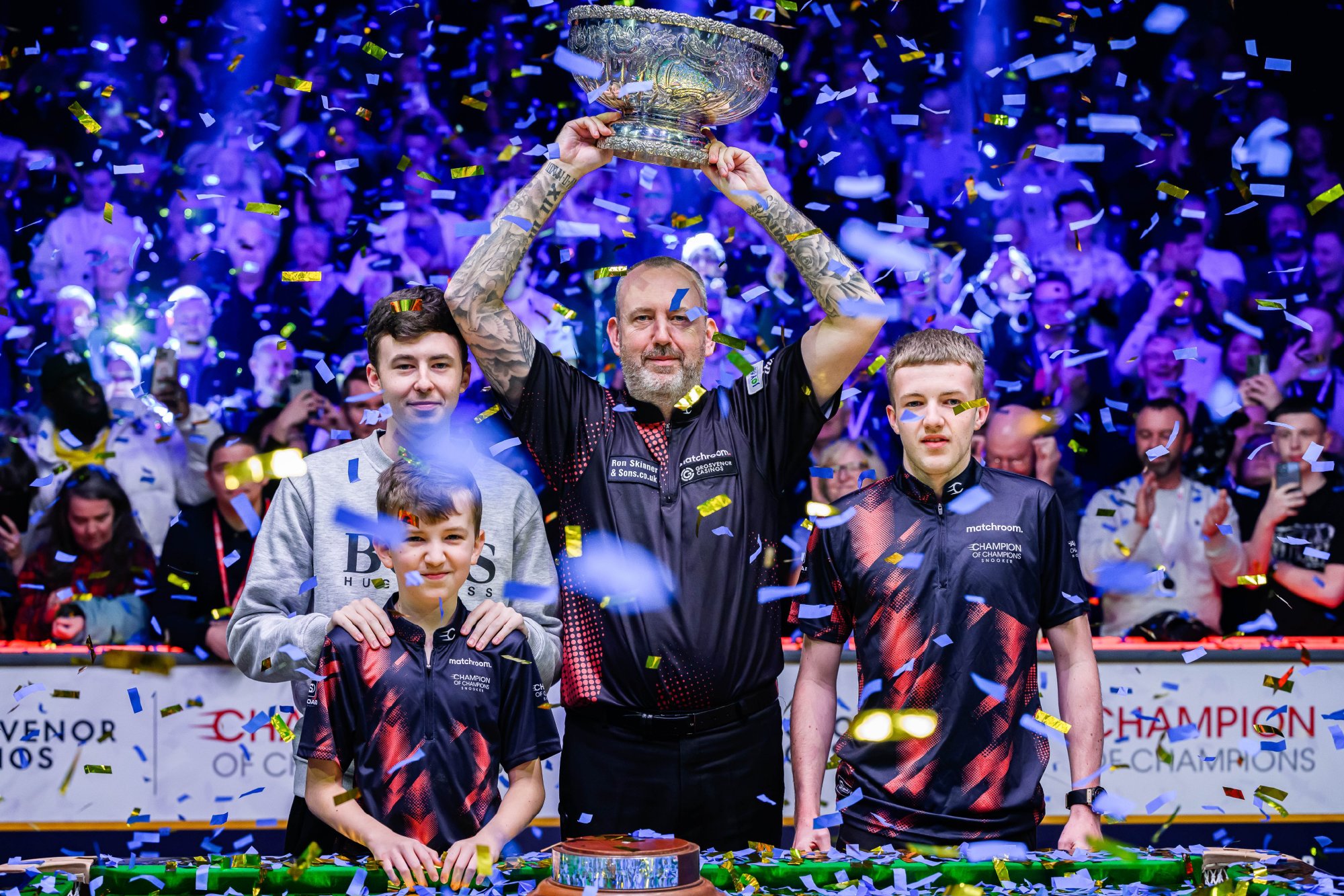 Mark Williams (C) of Wales celebrates after winning the Champion of Champions title in Bolton, England, November 17, 2024. / World Snooker Tour