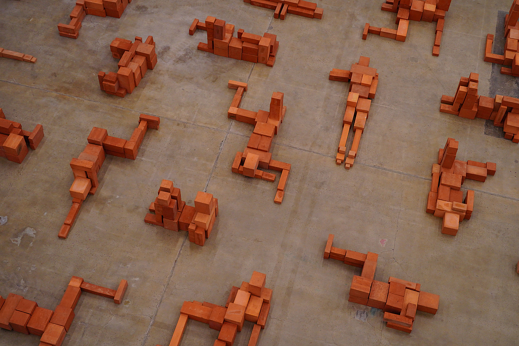 A photo taken on November 19, 2024, shows red clay brick sculptures created by Antony Gormley displayed at the 798 Art District in Beijing, China. /CFP