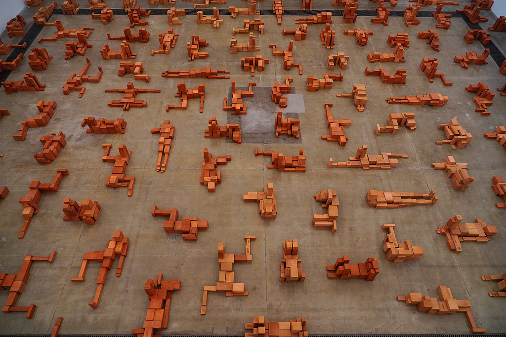 A photo taken on November 19, 2024, shows red clay brick sculptures created by Antony Gormley displayed at the 798 Art District in Beijing, China. /CFP