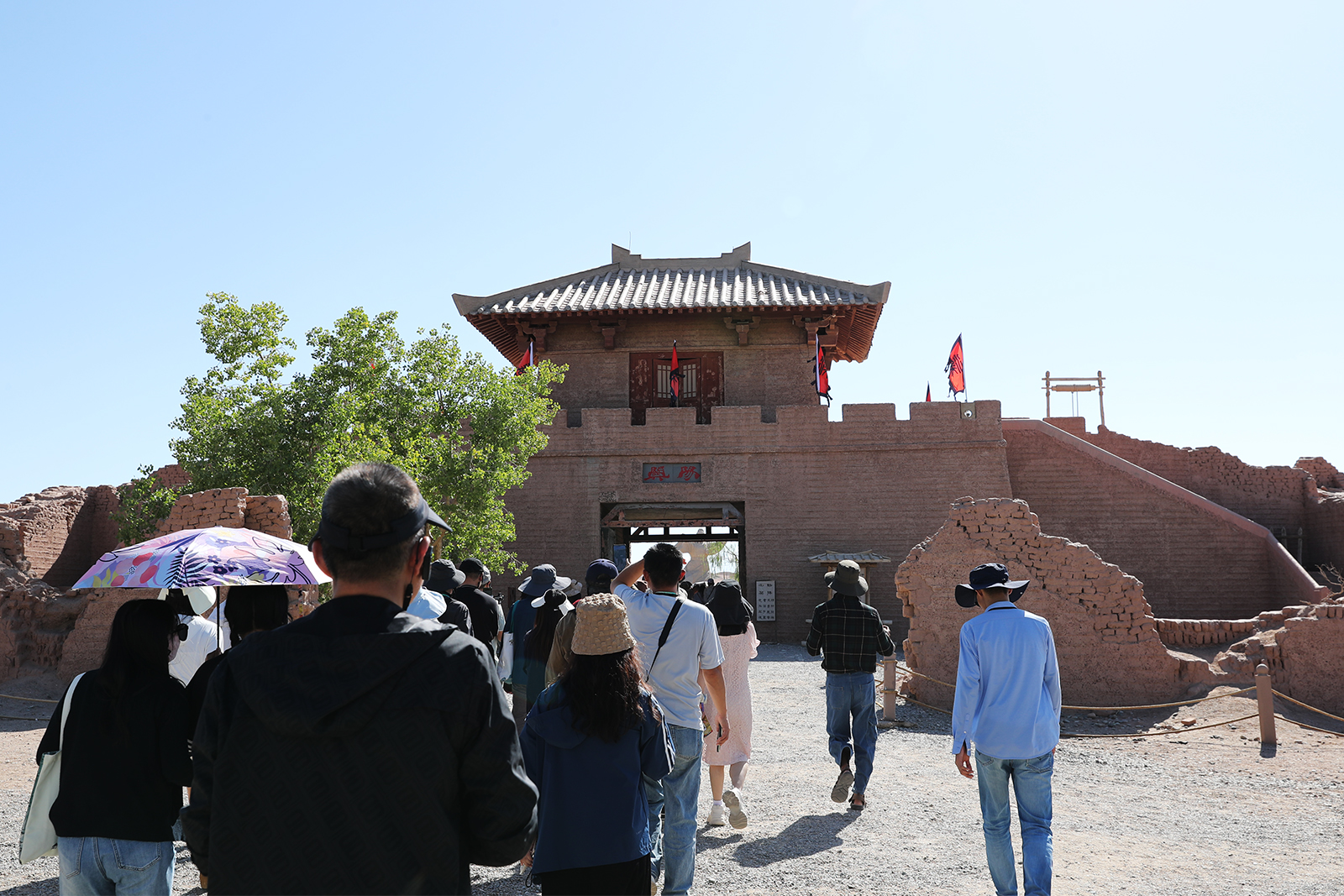 Visitors explore the Yangguan Scenic Area in Dunhuang, Gansu Province. /CGTN