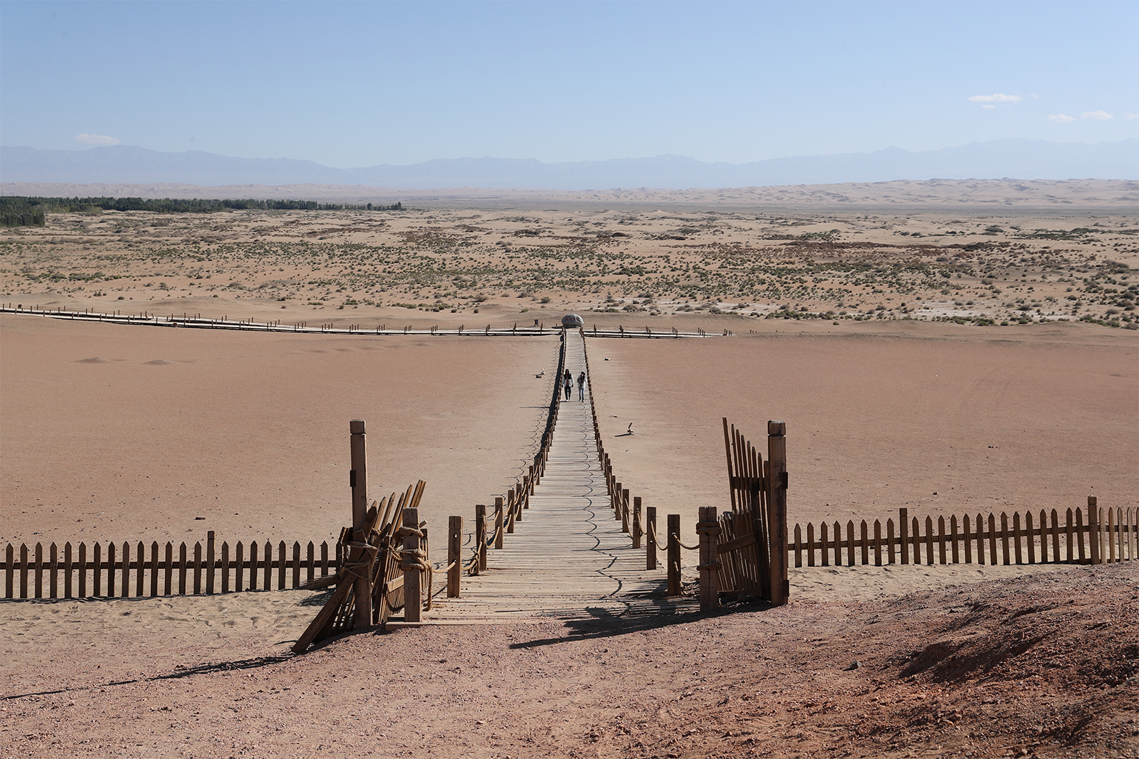 Visitors explore the area believed to be the site of the ancient Yangguan Pass at the Yangguan Scenic Area in Dunhuang, Gansu Province. /CGTN