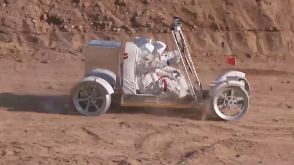 The video shows astronauts driving a lunar rover on the surface of the moon. /China Media Group