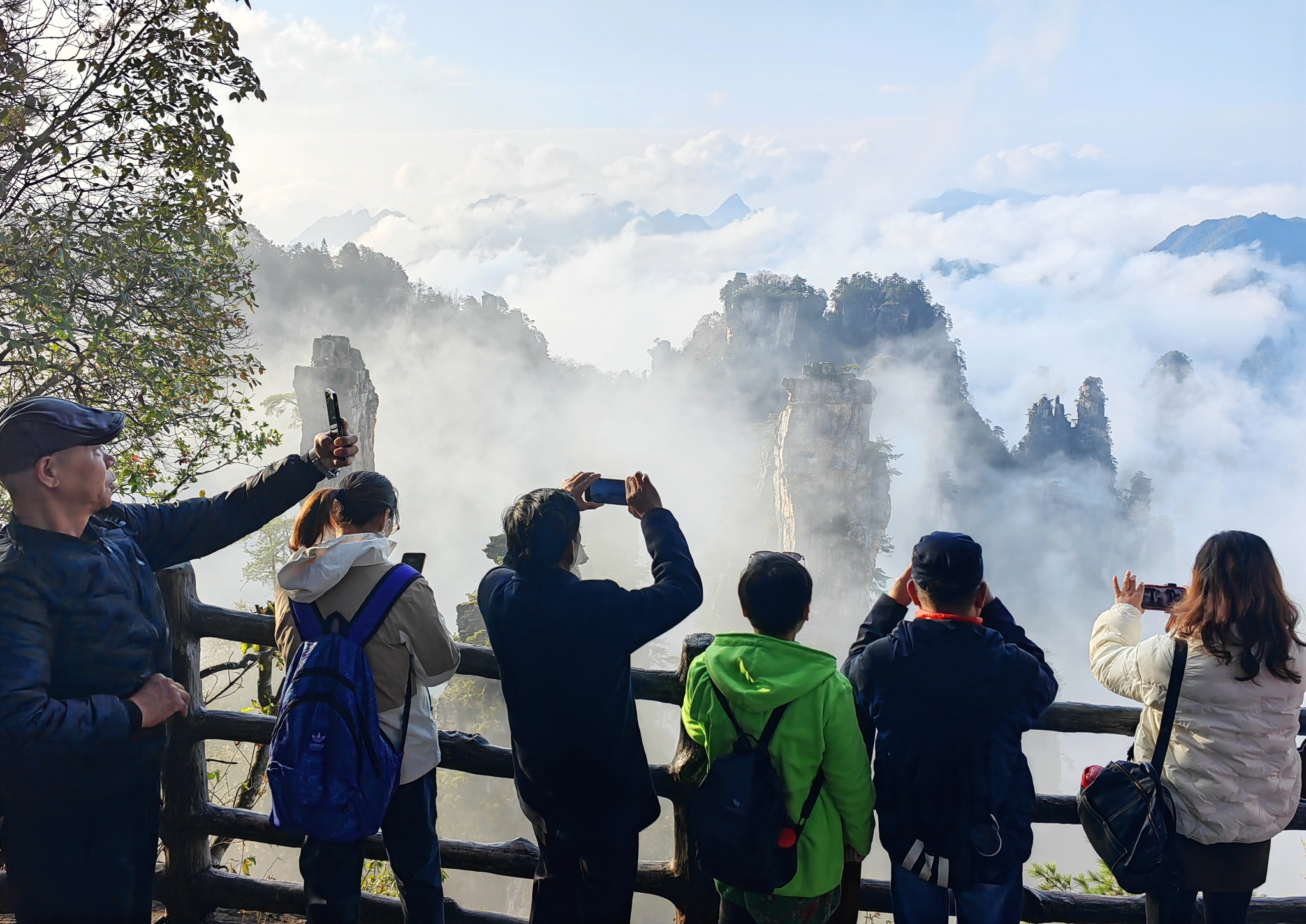 Visitors take photos at the Wulingyuan scenic area in Hunan Province on November 21, 2024. /CFP