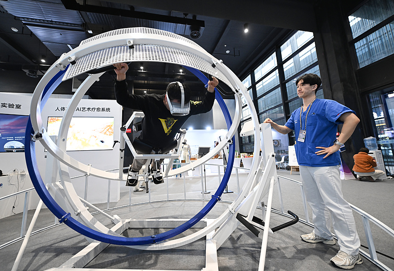 A visitor experienced an omnidirectional sensory art therapy system integrated with AIGC at the World Internet Conference, November 21, 2024, Wuzhen, Zhejiang Province, China. /CFP