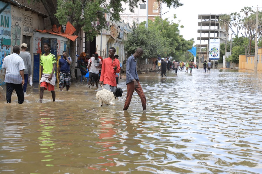 People walk through flooded streets in Beledweyne district, central Somalia, May 12, 2023. /Xinhua