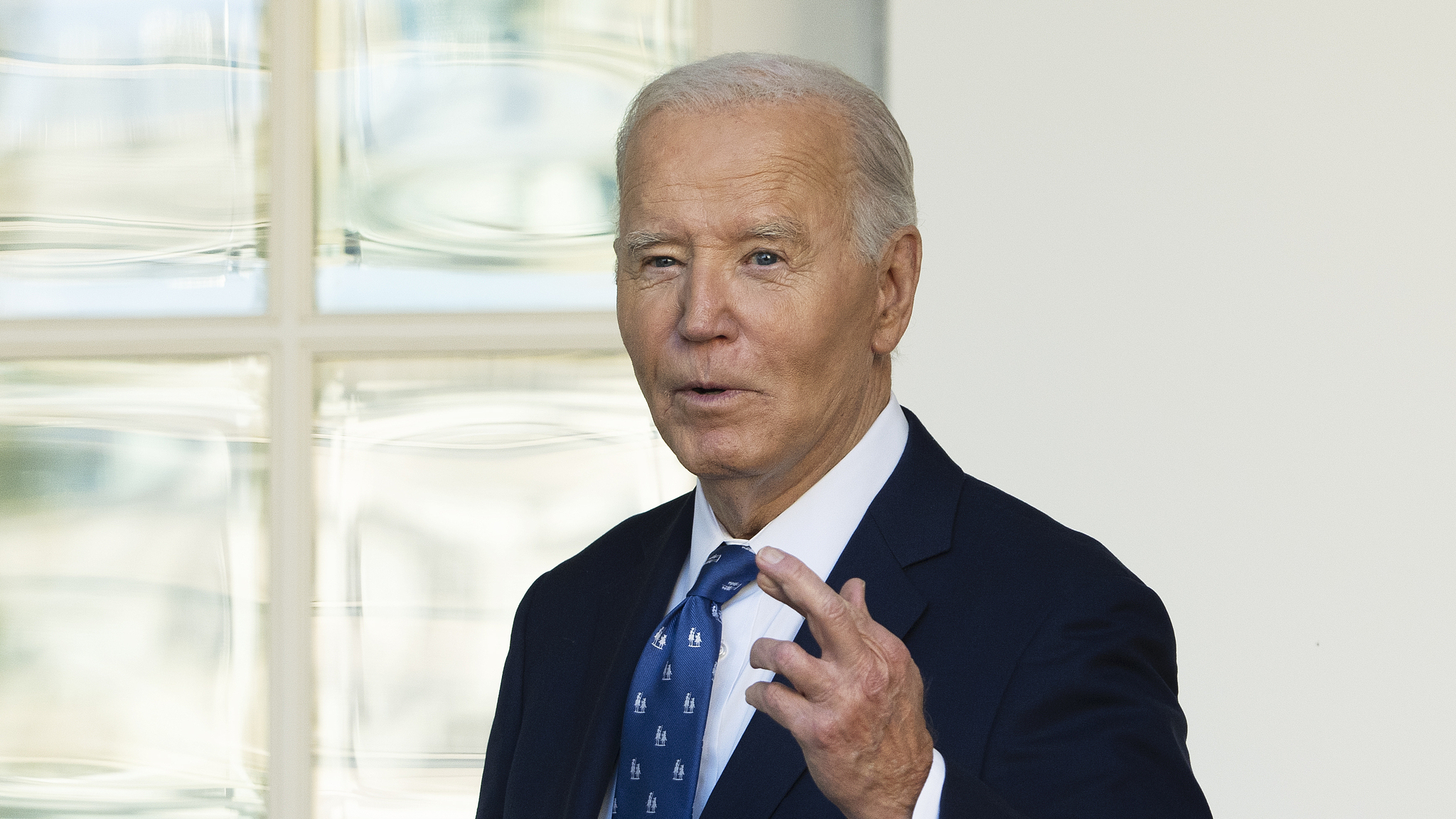 President Joe Biden, with his fingers crossed, speaks to reporters at the White House in Washington, November 26, 2024. /CFP