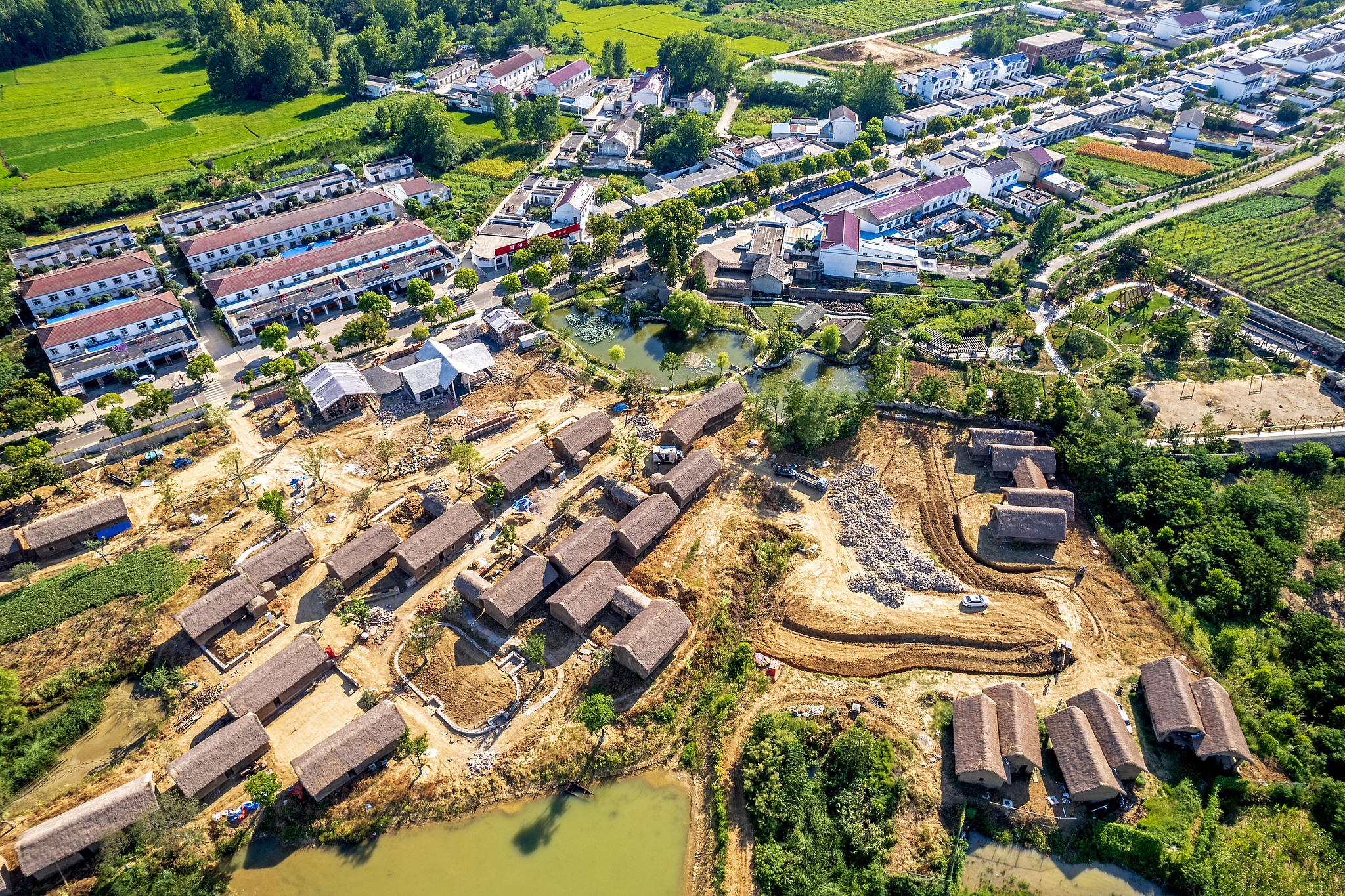 Aerial view of the old farmhouses and modern buildings in Xiaogang Village. /CFP