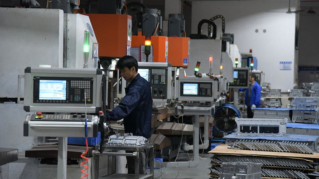 Workers operating machines at a factory workshop, Dongguan, Guangdong Province, November 21, 2024. /CFP