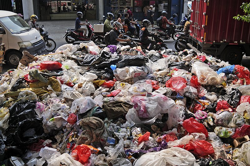 Motorists ride past garbage, most of them plastic, piled up on the side of a road in Jakarta, Indonesia, November 26, 2024. /CFP