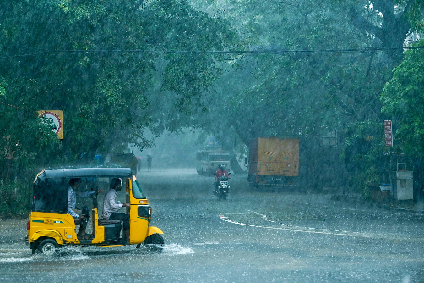 People commute on a street amid heavy rain ahead of a cyclonic storm in Chennai, India, November 30, 2024. /CFP