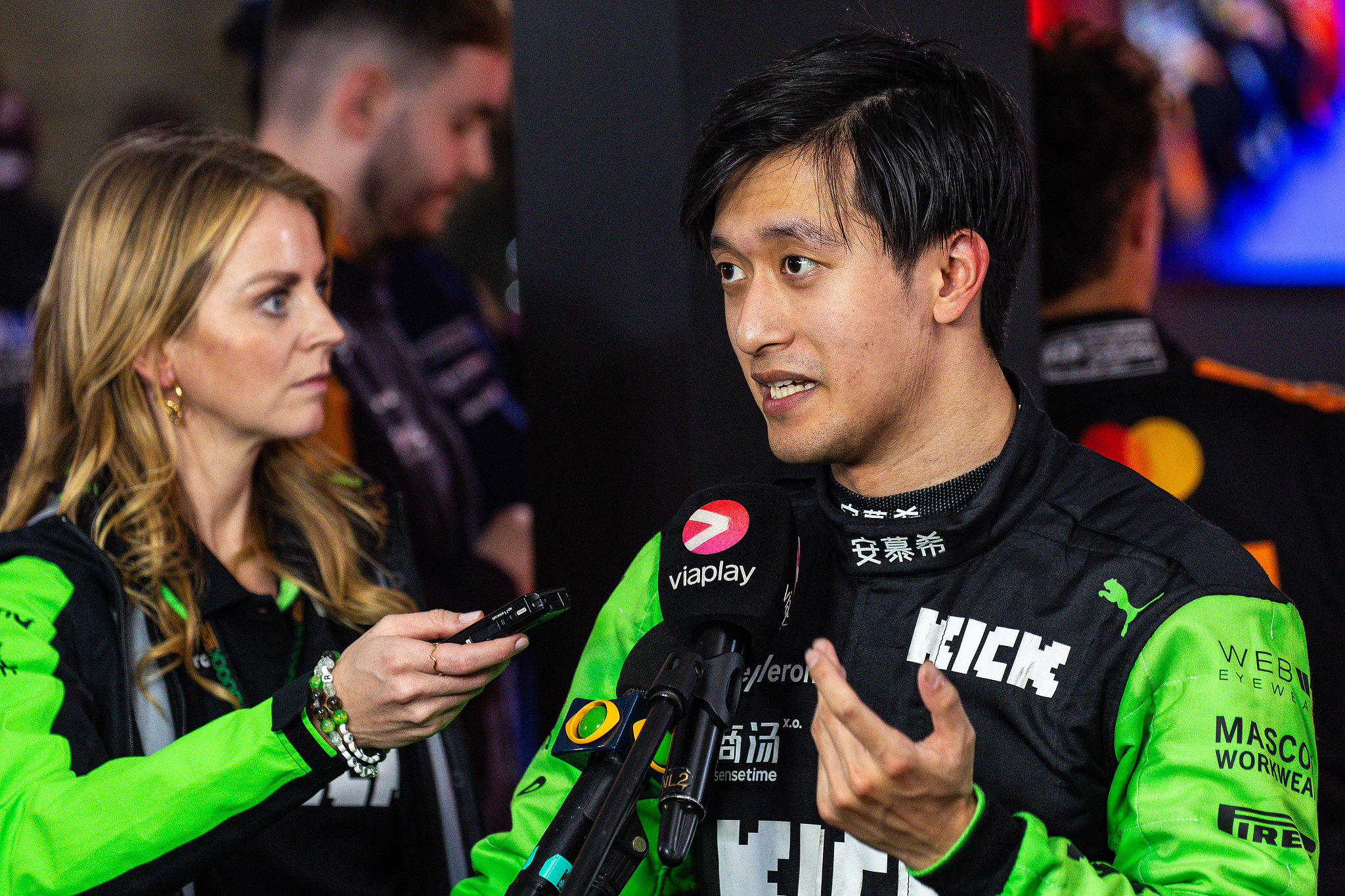 Zhou Guanyu (R) of Kick Sauber speaks in an interview after finishing in the eighth place in the Formula 1 Qatar Grand Prix at the Lusail International Circuit in Doha, Qatar, December 1, 2024. /CFP