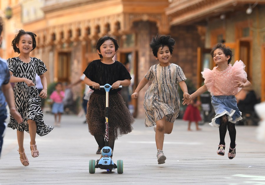 Children have fun on Dove Lane in Hotan City, northwest China's Xinjiang Uygur Autonomous Region, May 27, 2020. /Xinhua