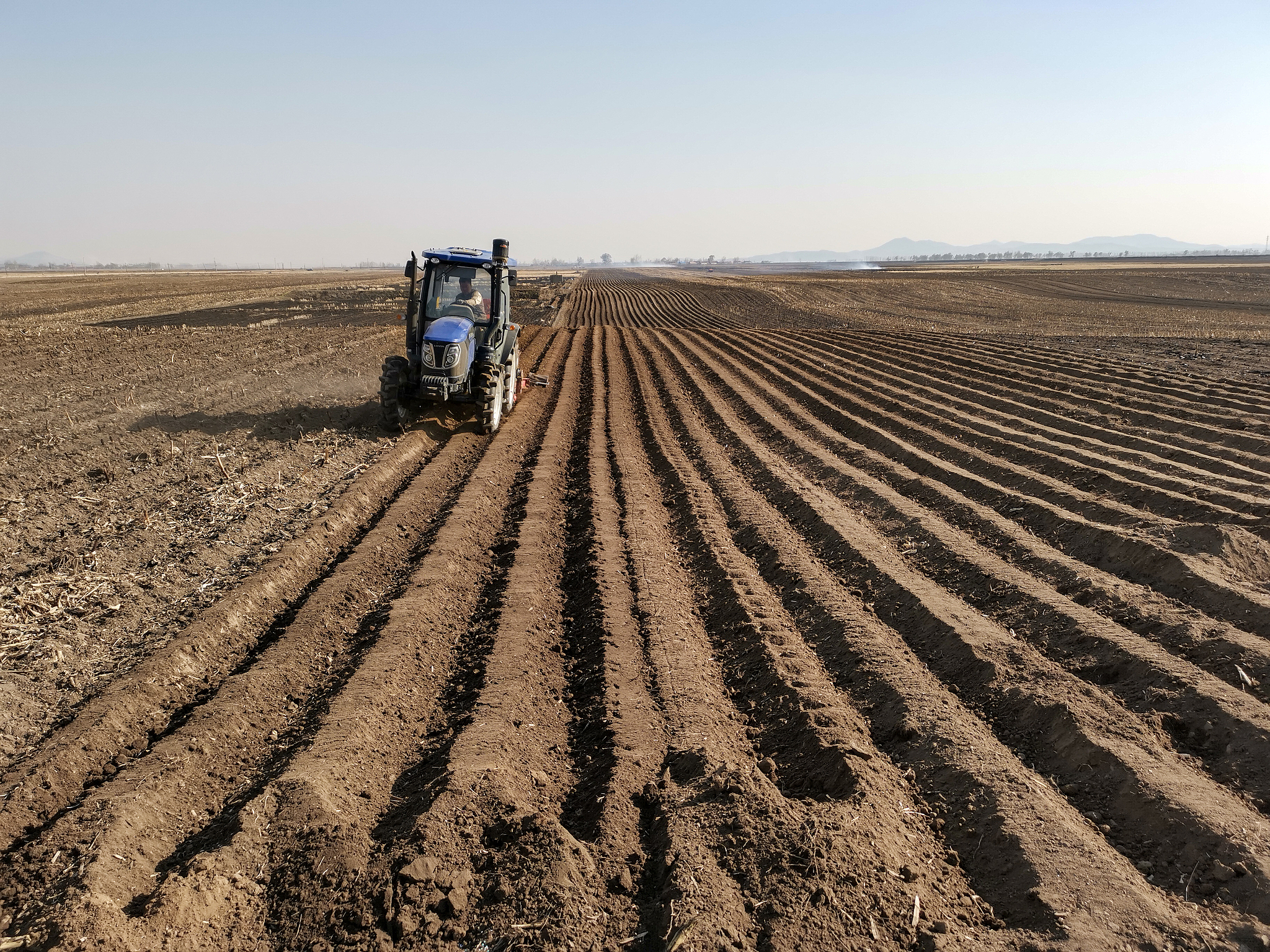 An agricultural machine prepares the field for planting in Jilin City, northeast China's Jilin Province, May 2, 2024. /CFP