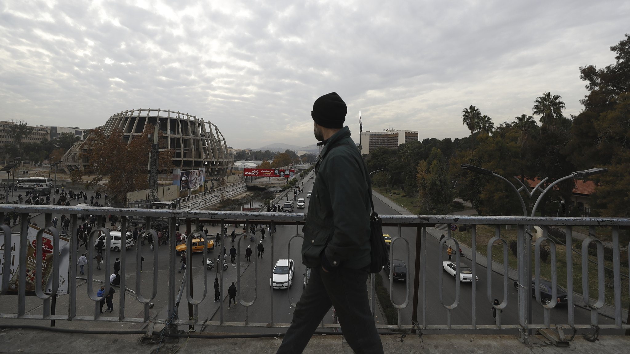 A man walks along a pedestrian bridge in Damascus, Syria, December 7, 2024. /CFP