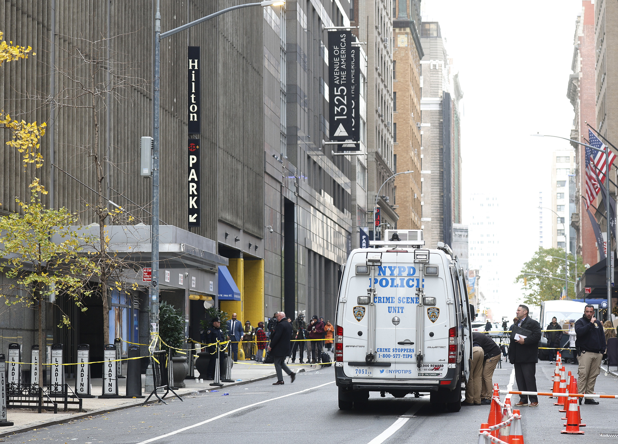 NYPD police officers investigate the crime scene around the New York Midtown Hilton after the fatal shooting of UnitedHealthcare CEO Brian Thompson in New York City, December 4, 2024. /CFP