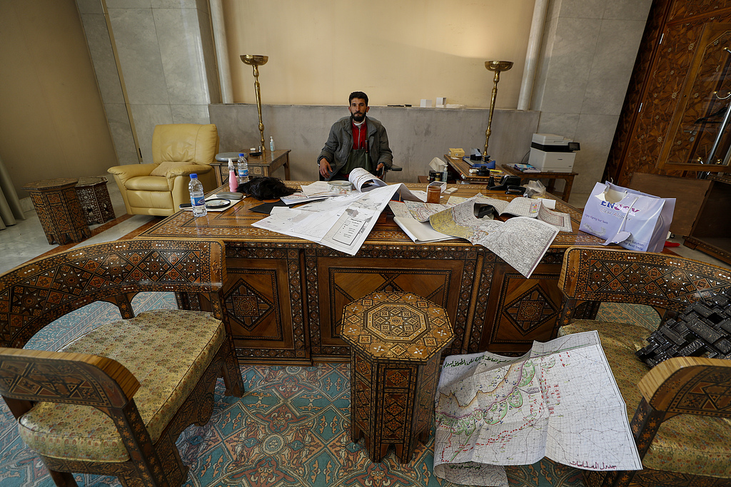 A Syrian opposition fighter sits inside an office at the Presidential Palace after armed opposition forces seized full control of Damascus, Syria, December 8, 2024. /CFP