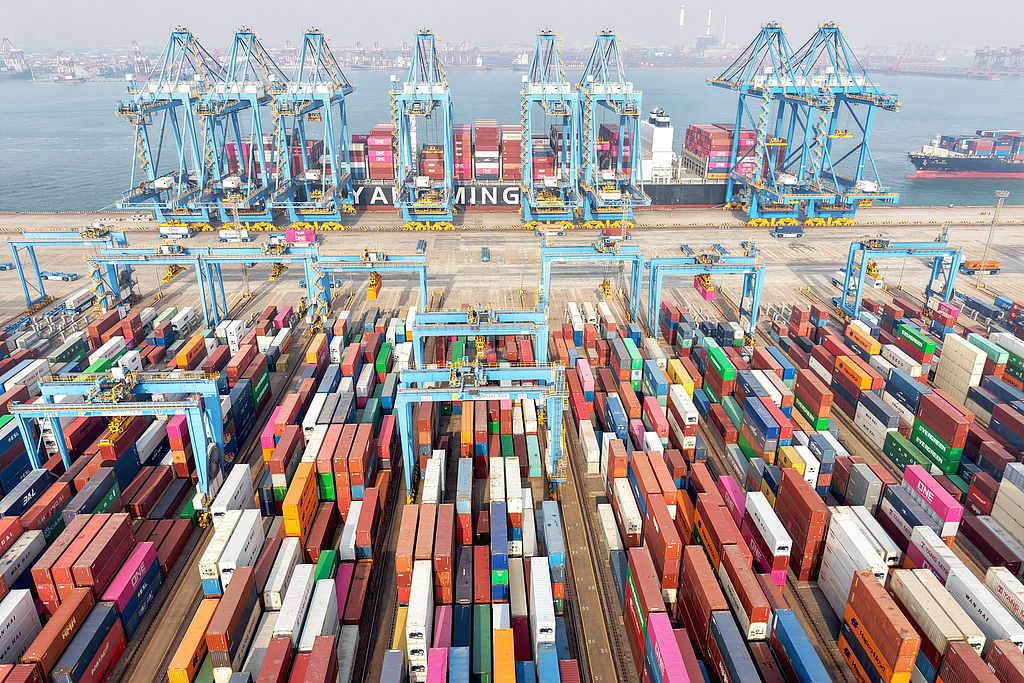 Cargo ships load and unload foreign trade containers at a fully automated terminal in Qingdao Port, east China's Shandong province, Dec 10, 2024./CFP