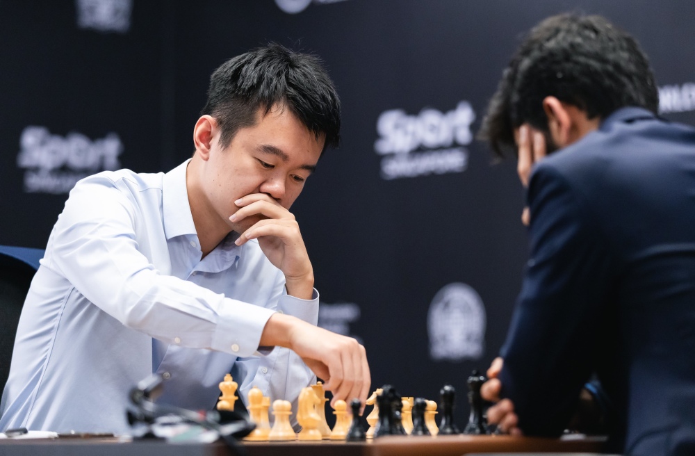 Ding Liren (L) of China competes against Gukesh Dommaraju of India at the International Chess Federation (FIDE) World Championship in Singapore, December 9, 2024. /FIDE