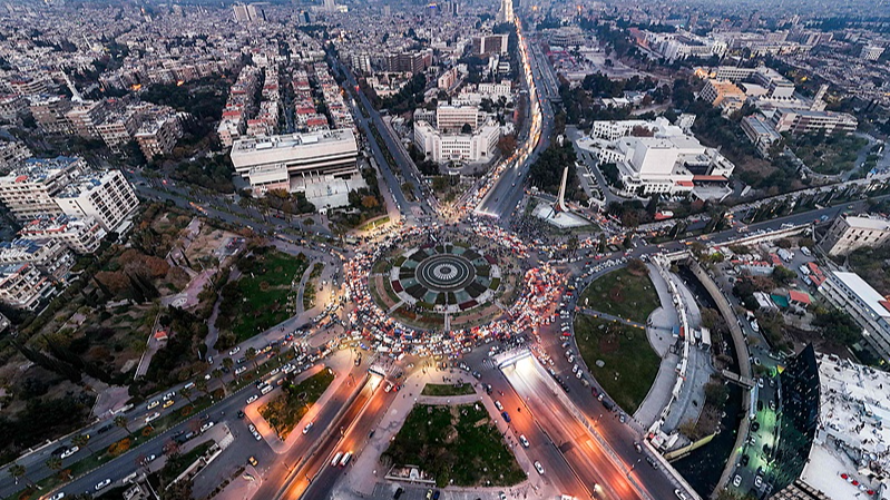 This aerial view shows traffic at Damascus' central Umayyad Square at sunset, December 10, 2024. /CFP