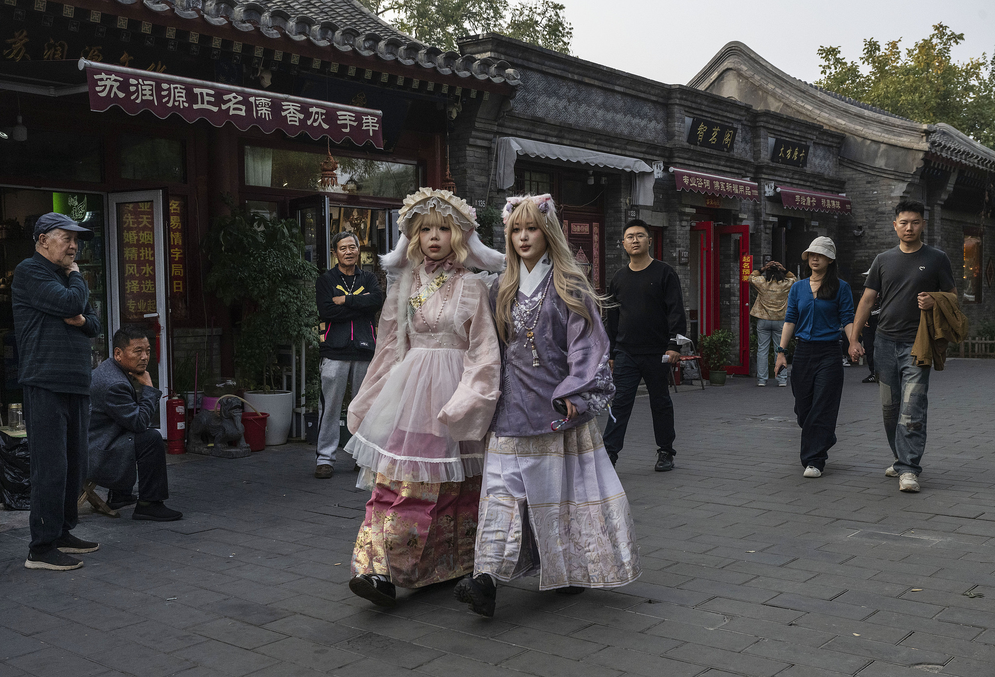 Women in cosplay costumes walk in a hutong in Beijing, October 14, 2024. /Getty