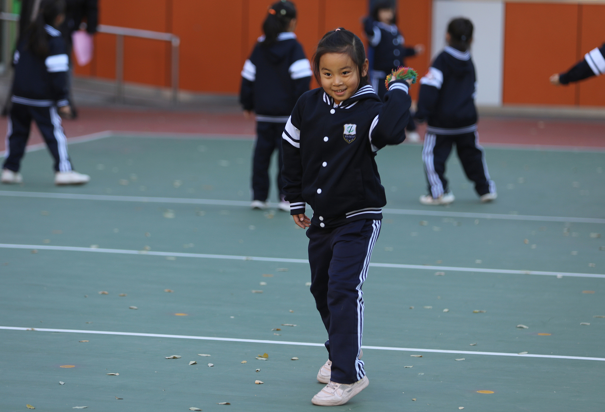 A schoolchild throws an earthbag at the Beijing Chaoyang District Experimental Primary School, Beijing, November 21, 2024. /CFP