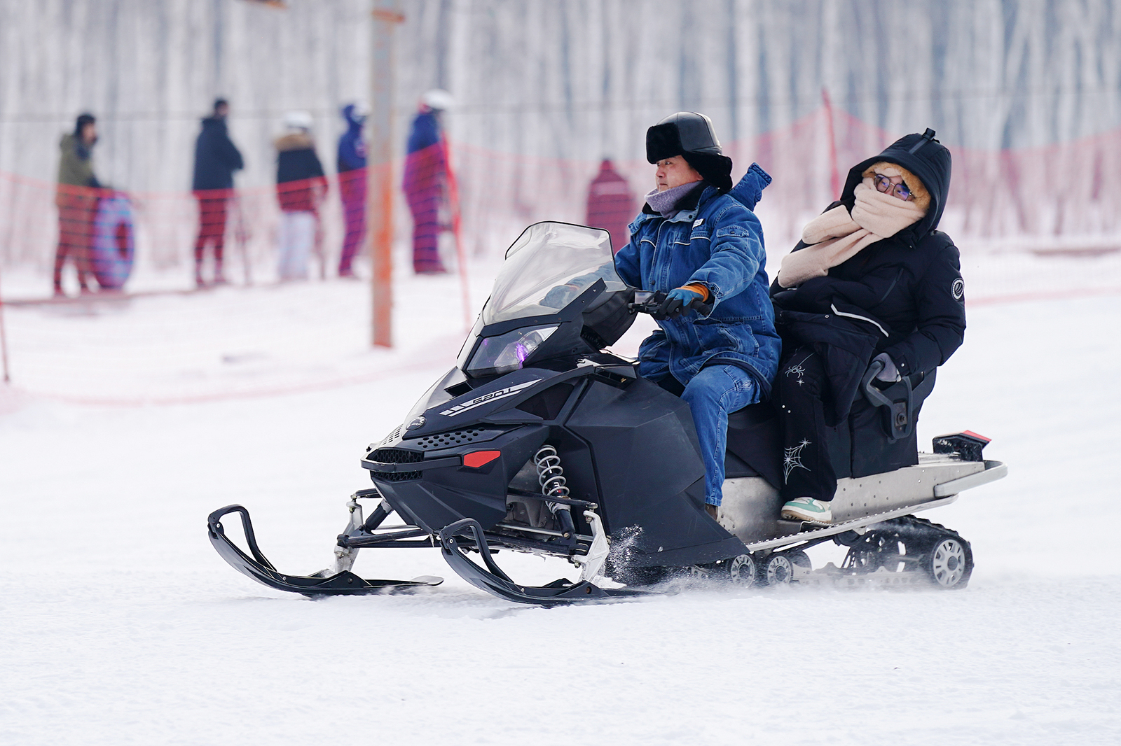 Visitors experience snowmobiling in Jinlin District, Yichun City, Heilongjiang Province on December 14, 2024. /CFP