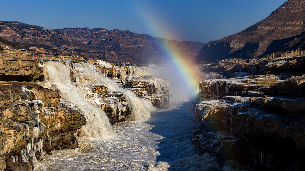 A photo taken on December 16, 2024 shows a rainbow over the Hukou Waterfall seen from Yan'an, Shaanxi Province, China. /CFP