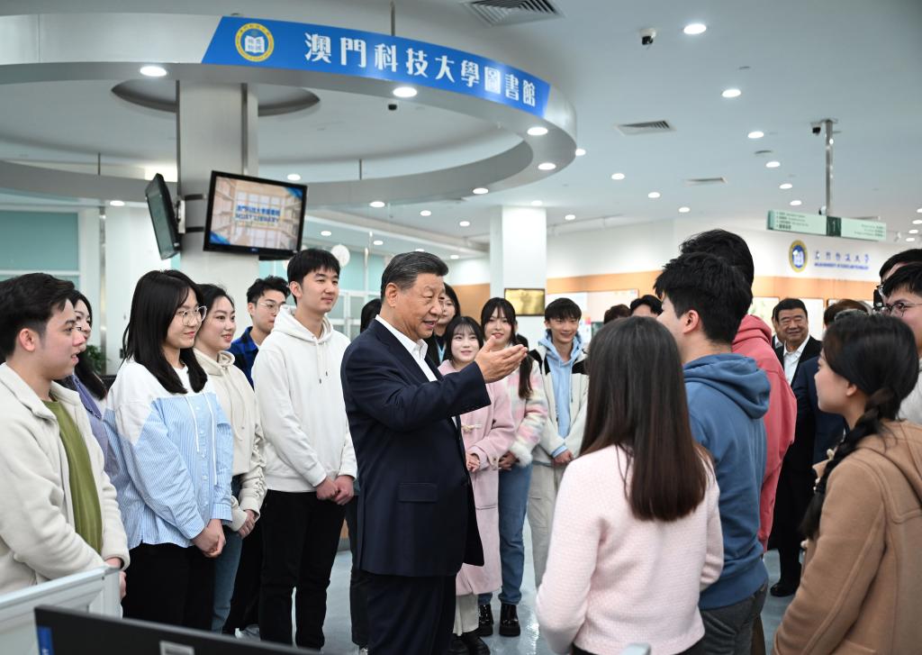 Chinese President Xi Jinping, also general secretary of the Communist Party of China Central Committee and chairman of the Central Military Commission, talks with students in the library of Macau University of Science and Technology in south China's Macao, December 19, 2024. /Xinhua