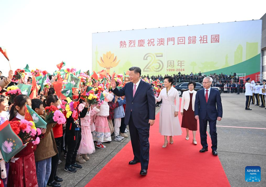 Chinese President Xi Jinping, also general secretary of the Communist Party of China Central Committee and chairman of the Central Military Commission, and his wife Peng Liyuan, wave to the crowd in south China's Macao Special Administrative Region, December 20, 2024. Xi left Macao on Friday after concluding a series of activities here. /Xinhua