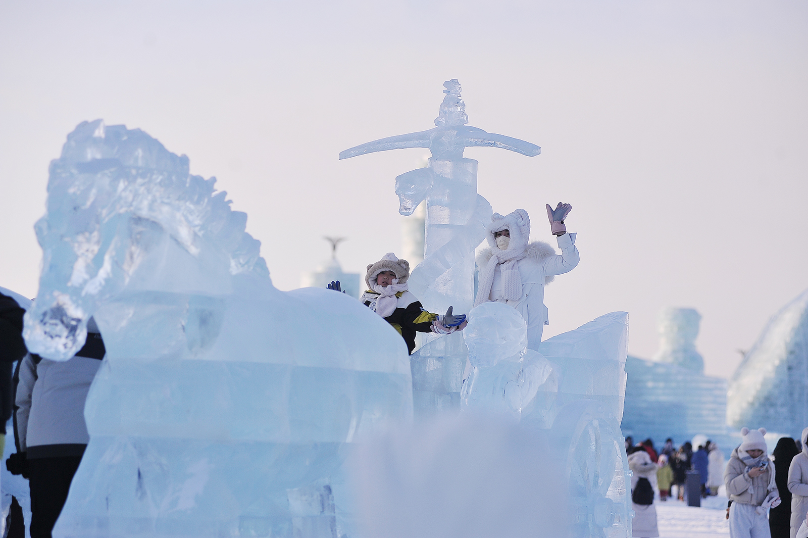 Visitors pose for photos at the Harbin Ice and Snow World in Harbin, Heilongjiang Province on December 21, 2024. /CFP