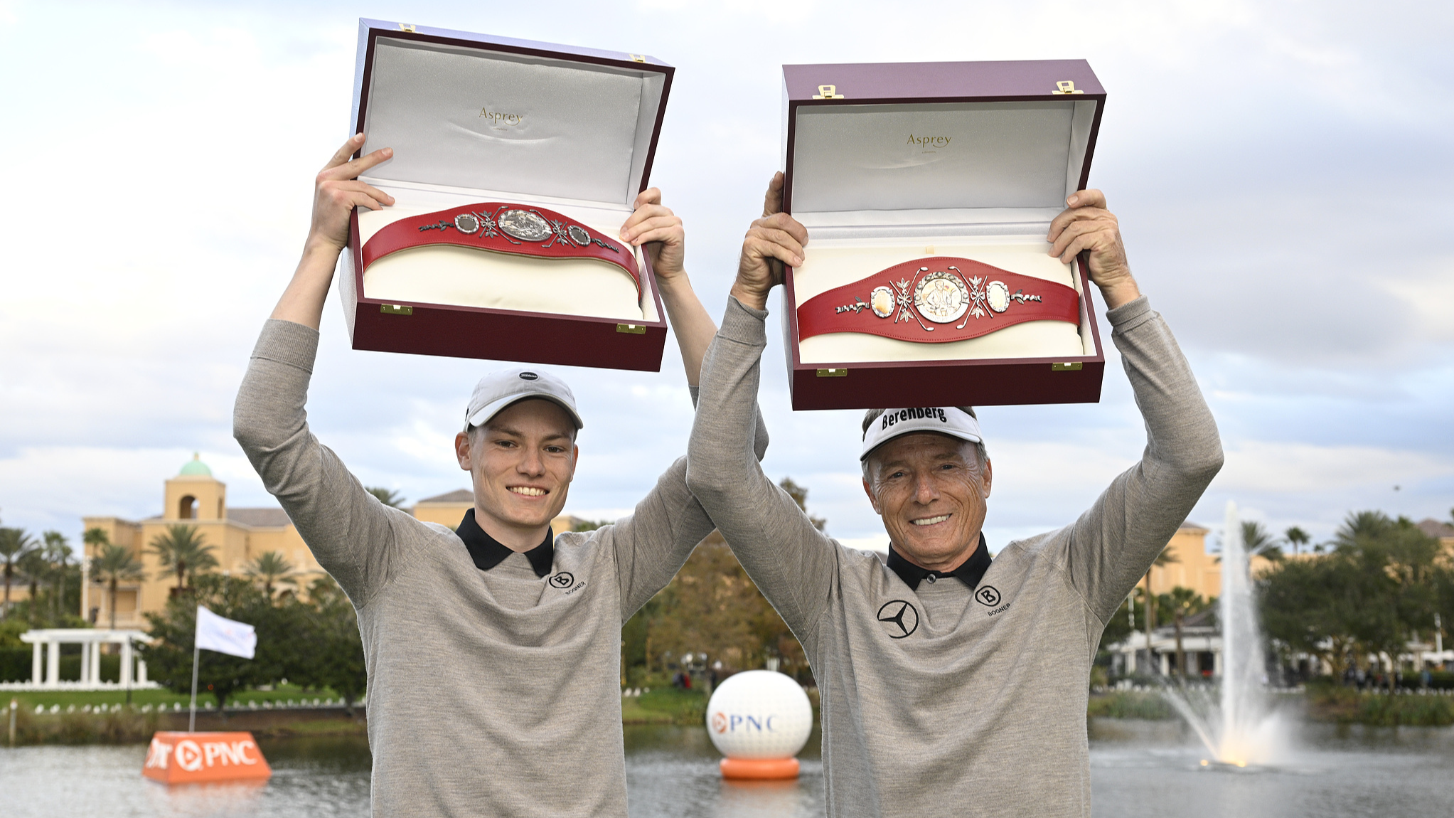 Bernhard Langer (R) and his son Jason Langer (L) hold the championship belts after winning the PNC Championship golf tournament in Orlando, Florida, December 22, 2024. /CFP