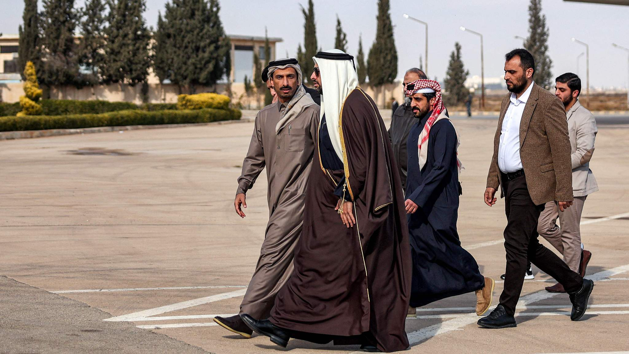 Qatar's Minister of State Mohammed al-Khulaifi walks with his delegation members upon arrival at Damascus International Airport in Damascus, Syria, December 23, 2024. /CFP