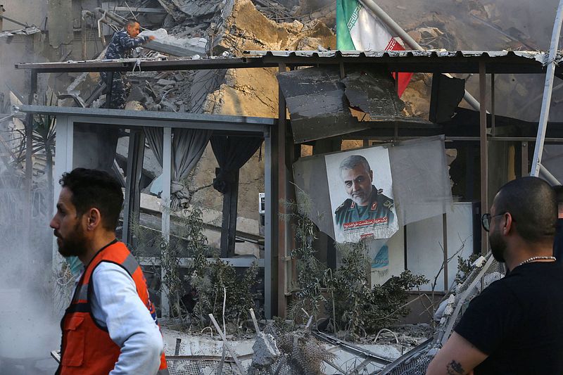 Emergency and security personnel work at the site of strikes, which hit a building next to the Iranian embassy in Syria's capital Damascus, April 1, 2024. /CFP