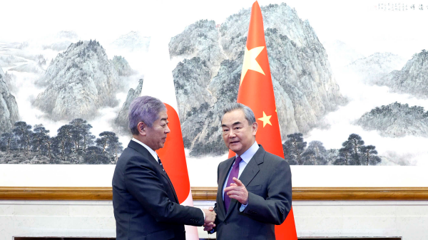 Chinese Foreign Minister Wang Yi (R) , also a member of the Political Bureau of the CPC Central Committee, shakes hands with Japanese Foreign Minister Takeshi Iwaya in Beijing, China, December 25, 2024. /Chinese Foreign Ministry