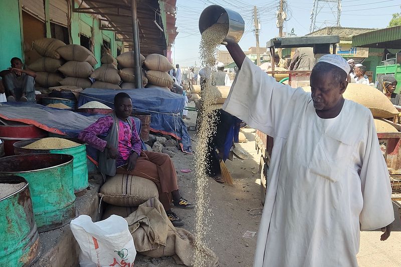 A grain vendor sells various pulses at his shop in a market in Sudan's eastern state of Gedaref, April 17, 2024. /CFP