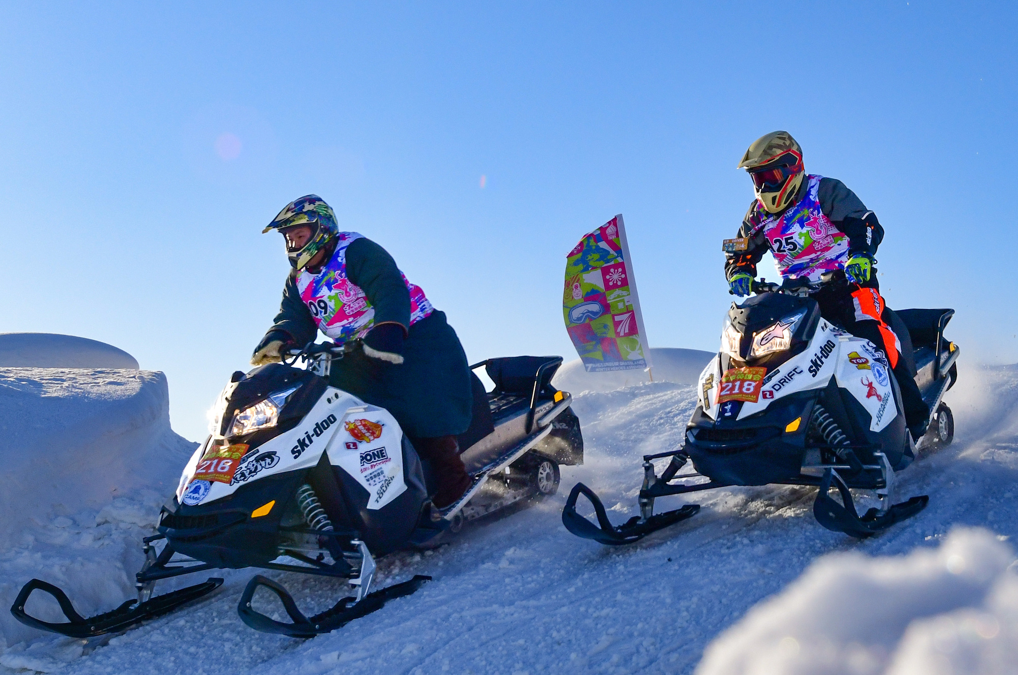 Competitors take part in the snowmobile cross-country grand prix at the 7th Winter Heroes Games in Inner Mongolia on December 25, 2024. /CFP