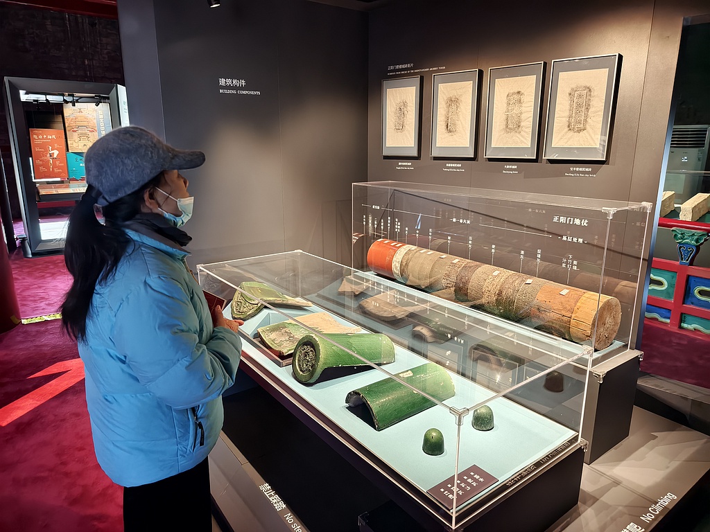 A visitor views the building beam and tile exhibits of Zhengyangmen on December 26, 2024. /CFP