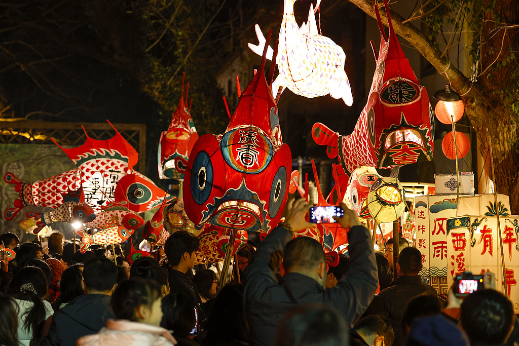 Dutch visitors dance together with locals during a fish lantern parade in Xixinan Ancient Village on December 26, 2024. /CFP