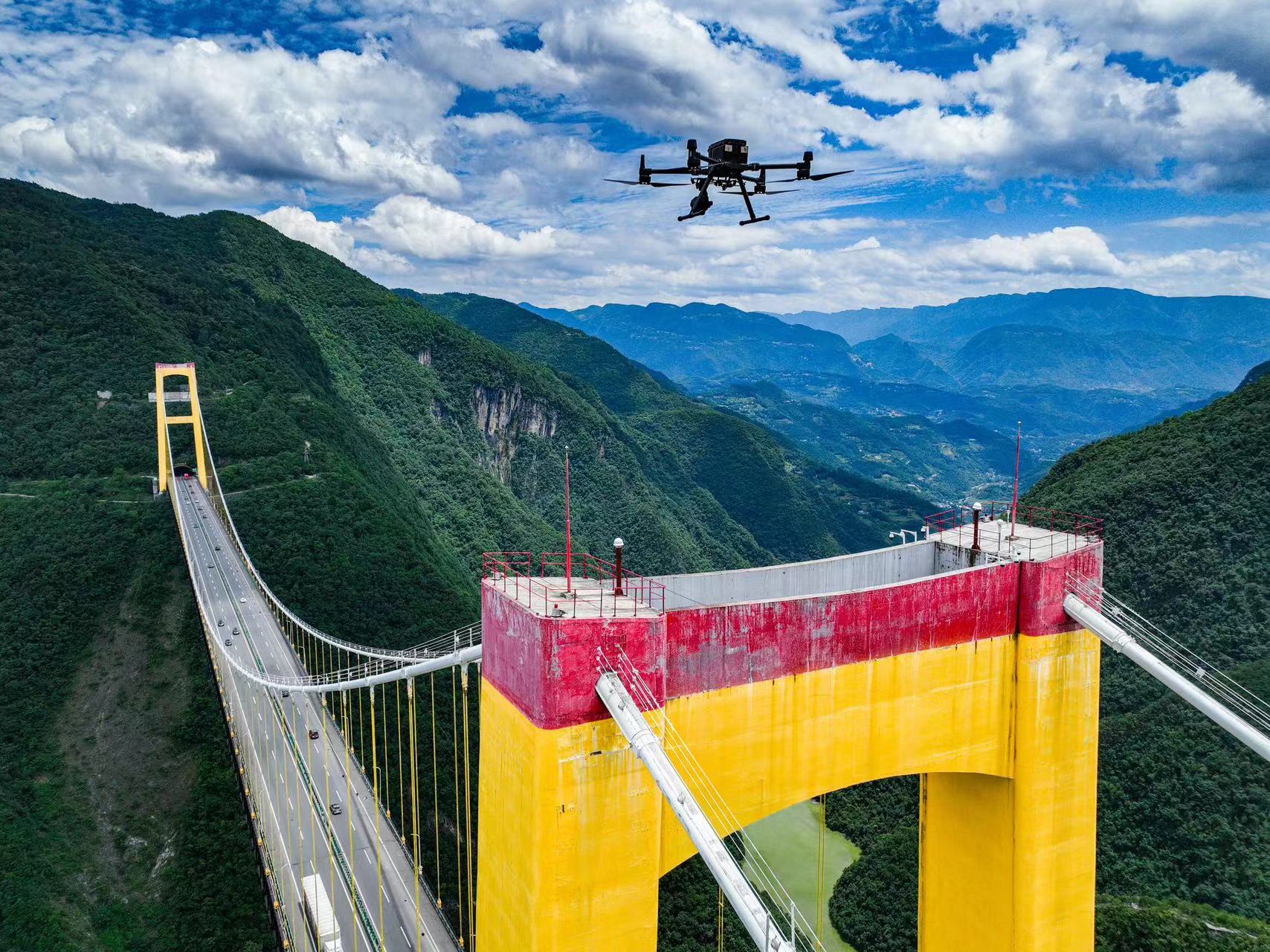 A drone patrols over the Sidu River Bridge in central China's Hubei Province. /CMG