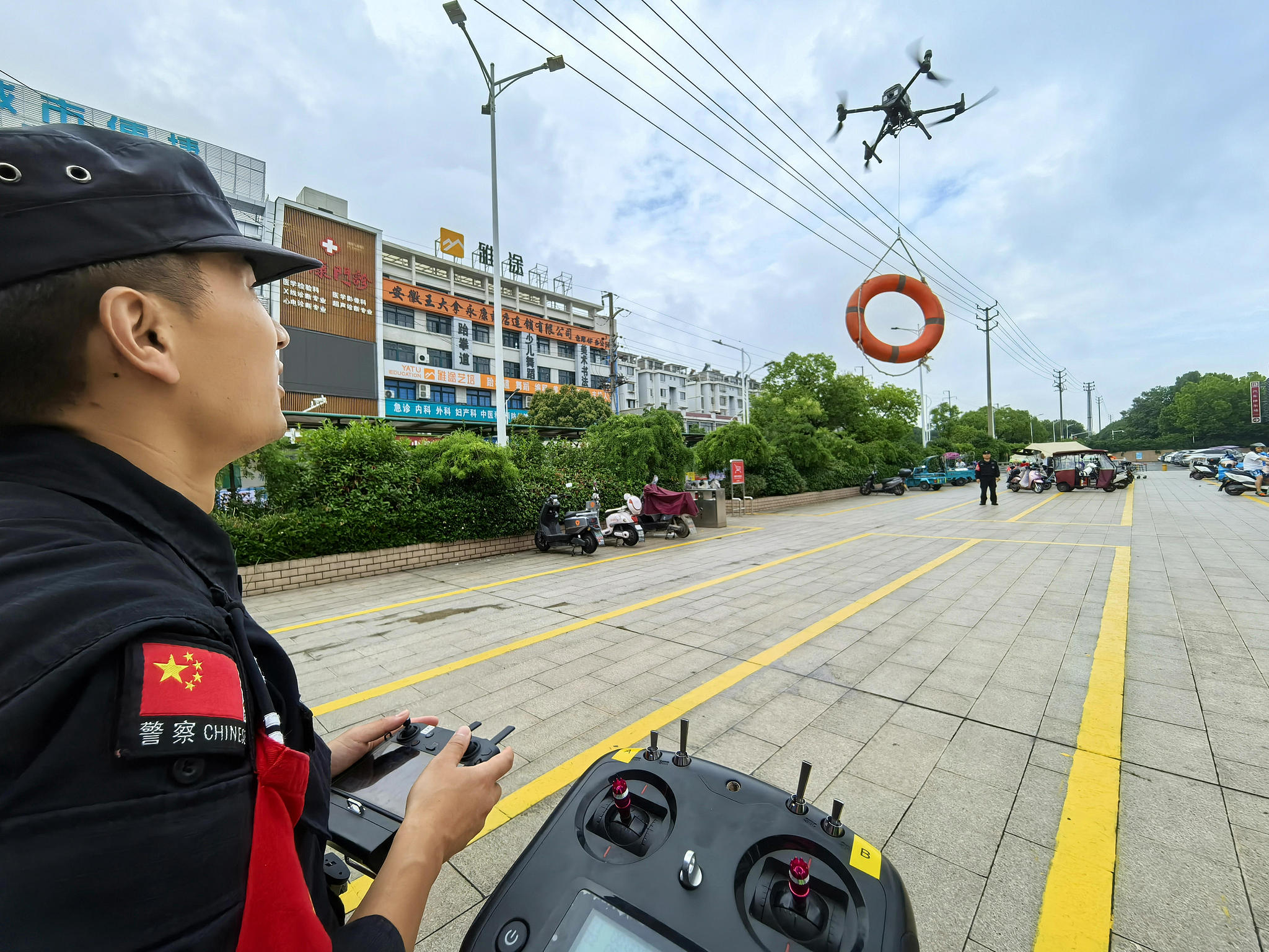 A policeman tests a drone during patrol in eastern China's Anhui Province, December 27, 2024. /CFP