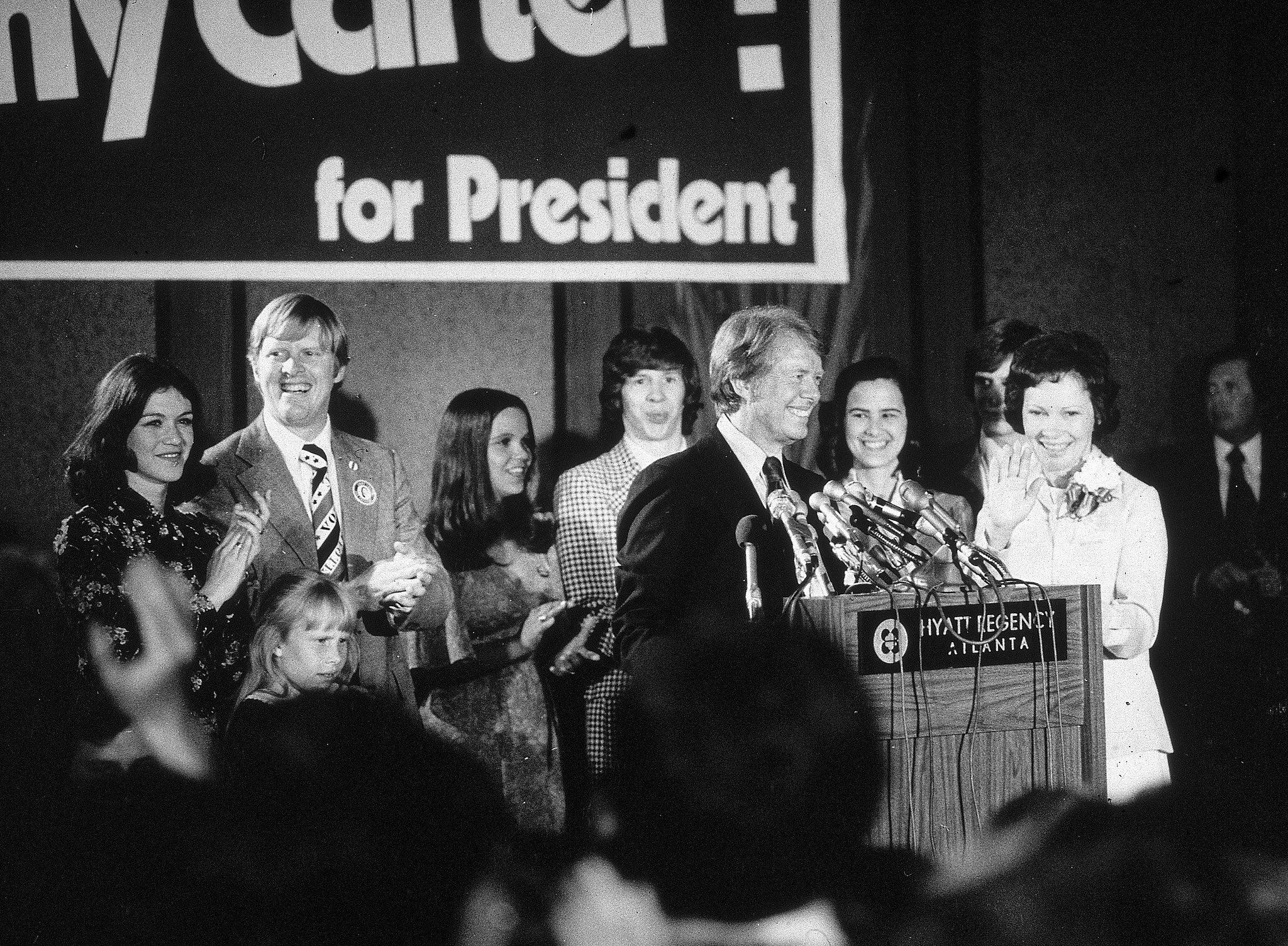 Democratic presidential candidate Jimmy Carter speaks at a podium while his brother Billy, wife Rosalynn and other family members applaud on election night at Hyatt Regency Hotel, Atlanta, Georgia, 1976. /CFP