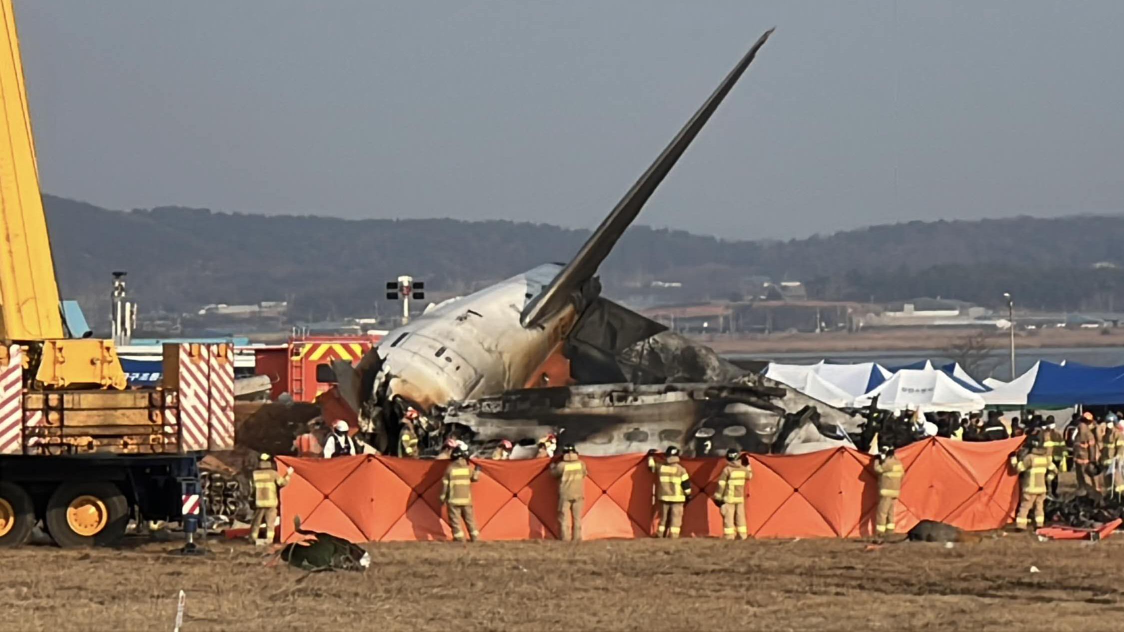 Firefighters and recovery teams work at Muan International Airport in Muan, South Korea, December 30, 2024. Shane Hahm/CGTN