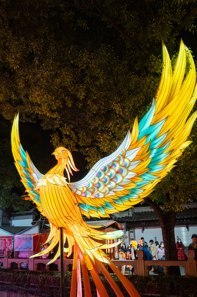 A phoenix-shaped lantern with outspread wings glows at the Yuyuan Garden Lantern Festival in Shanghai on January 1, 2025. /CFP