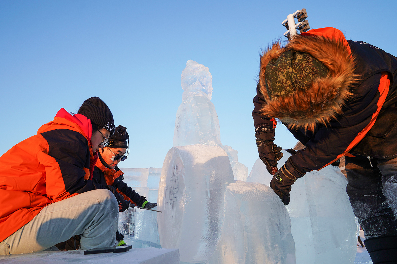 Artisans work on ice sculptures that are part of the ice Terracotta Warrior display at Harbin Ice and Snow World in Heilongjiang Province on January 4, 2025. /CFP