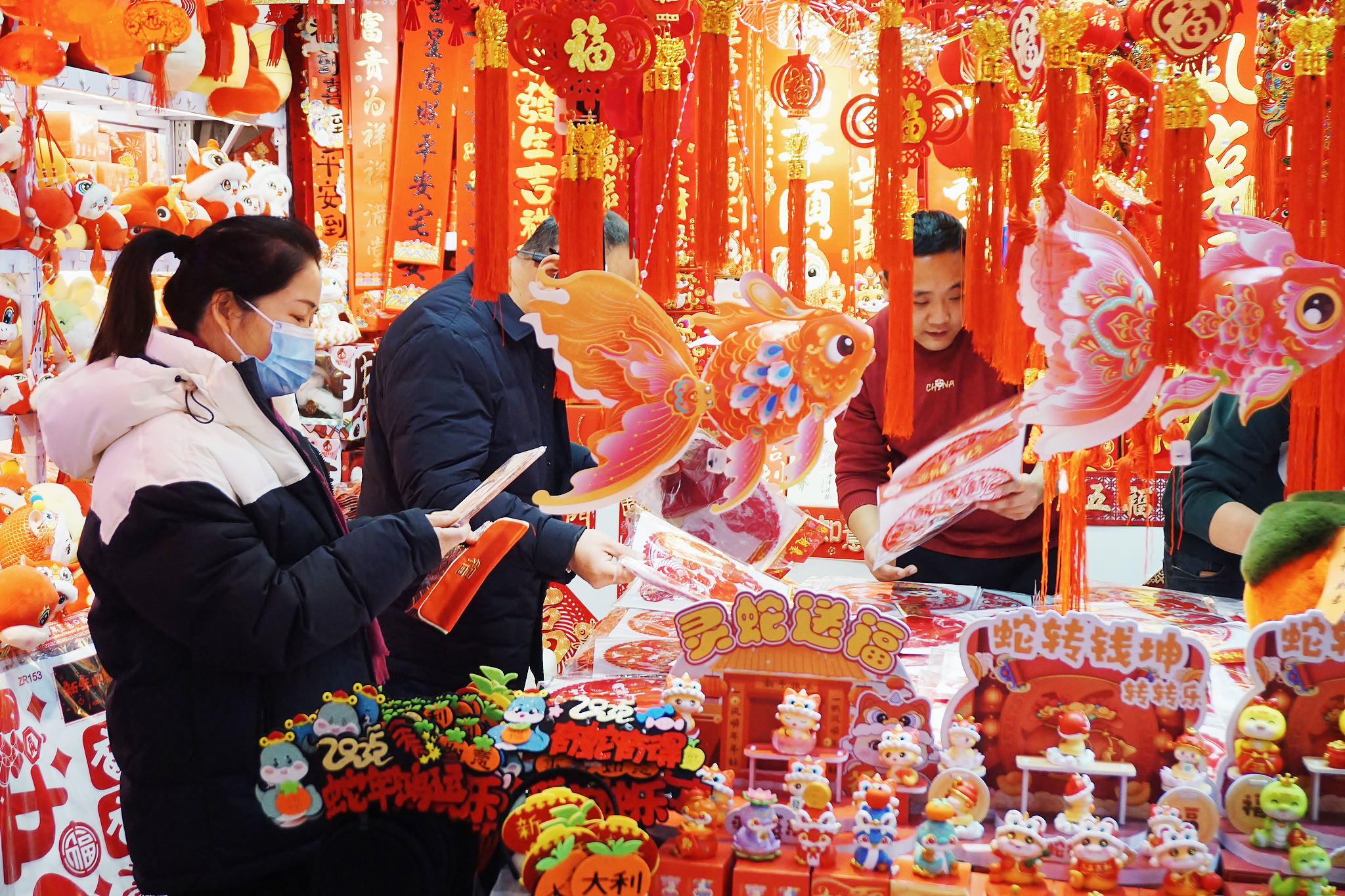 People select decorations for the upcoming Spring Festival at a market in Beijing on January 4, 2025. /CFP