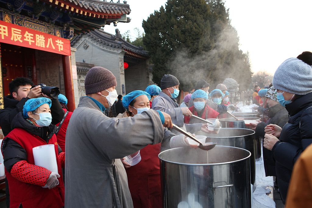 People line up in long queues to receive Laba porridge in front of the gate of Daci'en Temple in Xi'an, northwest China's Shaanxi Province, January 7, 2025. /CFP